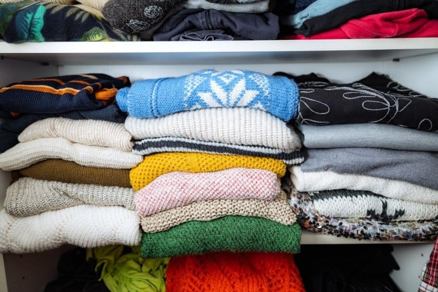 sweaters in closet shelf