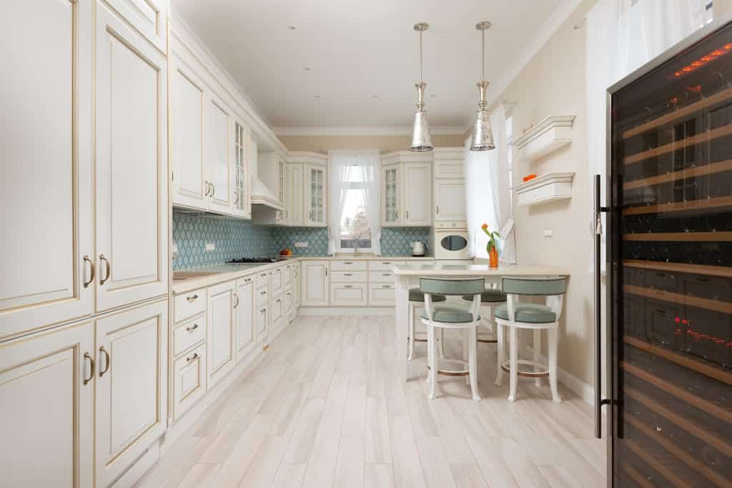 Spacious and elegant kitchen featuring white cabinetry and modern appliances, perfect for home decor inspiration.